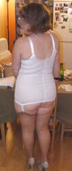 Trampy secretary in girdle, pantyhose and platform high-heeled slippers